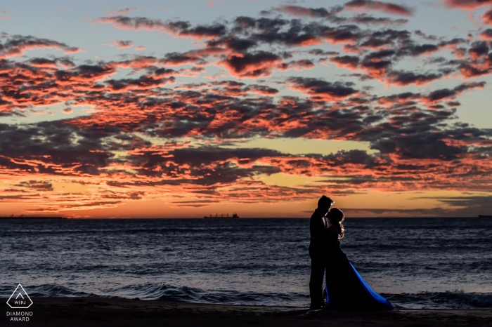 Photo by: <a href="https://www.wpja.com/photos/diamond-award-top-wedding-engagement-photographer/2256211">Minifeel Lu - Taiwan Wedding Photographer</a> Taipei Taiwan formal prewedding portrait at the beach at sunset with great clouds