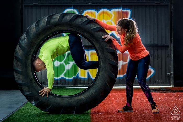 Valencia engagement portrait session with a couple working out at the gym with the tractor tire