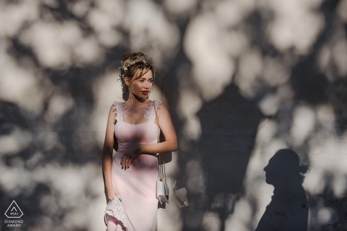 Photo by: <a href="https://www.wpja.com/photos/diamond-award-top-wedding-engagement-photographer/2254926">Lubow Polyanska - Czech Republic Wedding Photographer</a> Czech Republic Engagement Photograph of couple in shadows and sunlight against wall