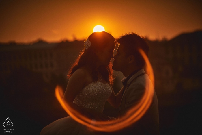 Prague Czech Republic Sunset Flare Engagement Photograph of Couple