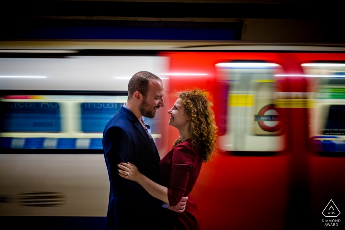 Ritratto di una coppia con la metropolitana in movimento durante la sessione di fidanzamento a Londra