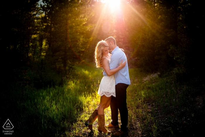 CO wedding engagement portrait of a couple in the sun and trees with grass  | Colorado pre-wedding photographer session