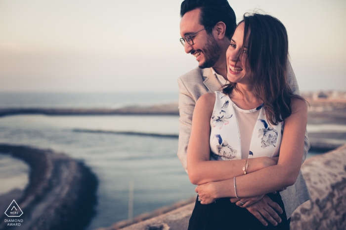 France wedding photographer engagement portrait of a couple looking over water | Paris pre-wedding pictures