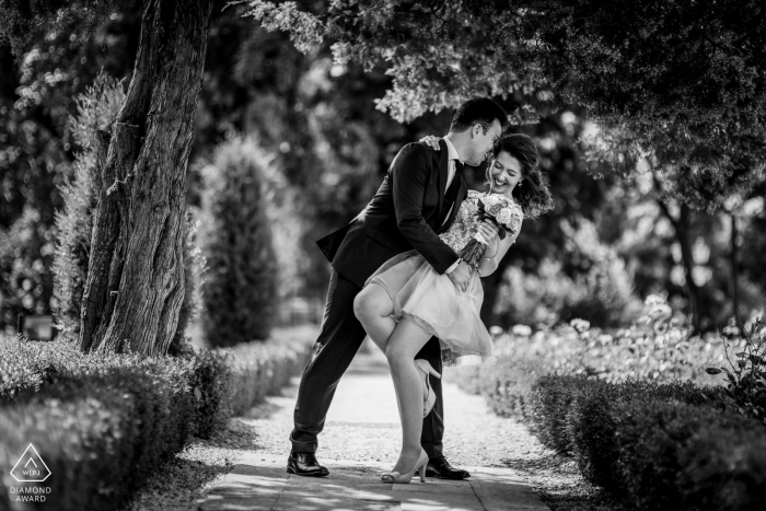 Dipping black and white pre-wedding engagement pictures of a couple having some fun | Romanian couple photography session