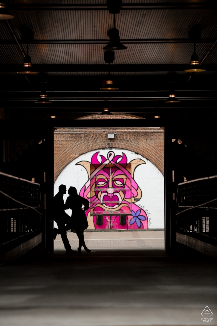 Photo by: <a href="https://www.wpja.com/photos/diamond-award-top-wedding-engagement-photographer/2329286">Penny McCoy - Columbia Heights Minnesota Couple silhouette with queen mural | MN engagement photographer