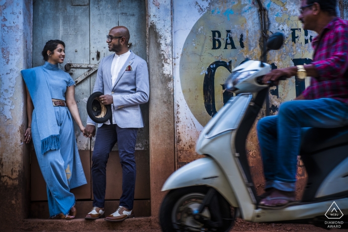 Goa couple shoot for engagement portraits with moped scooter passing by