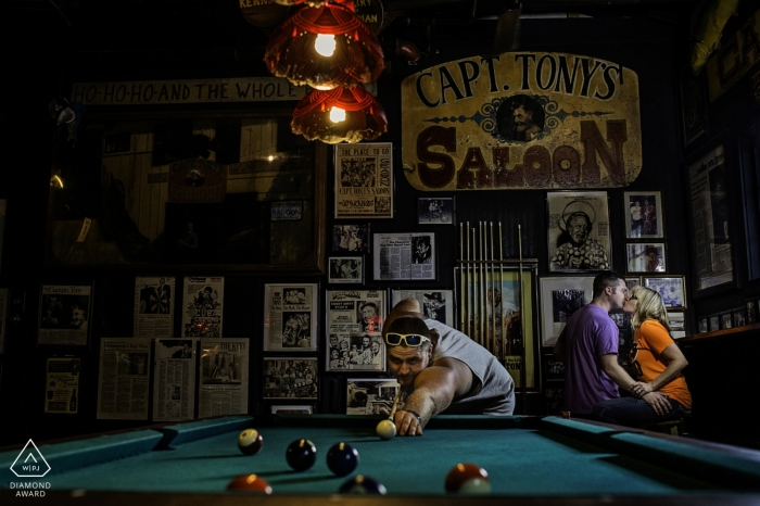 Florida wedding engagement portrait of a couple in pool hall Florida wedding engagement portrait of a couple in pool hall | Key West pre-wedding photographer session