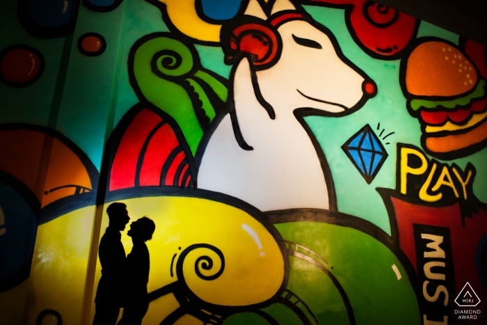 China wedding photographer engagement portrait of a couple with cartoon painted mural | Fujian pre-wedding pictures