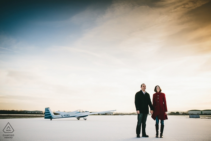 Photo by: <a href="https://www.wpja.com/photos/diamond-award-top-wedding-engagement-photographer/2346706">Aaron Storry - Kettering Northamptonshire East Midlands engagement portraits of a couple at the airport with planes | Northamptonshire photographer pre-wedding photographer pictures