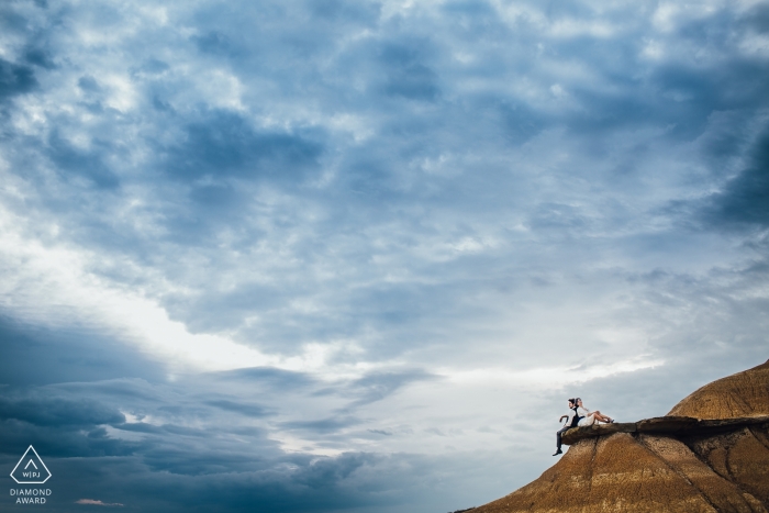 Spain pictures on the mountain cliff of a couple by a top Madrid wedding engagement photographer