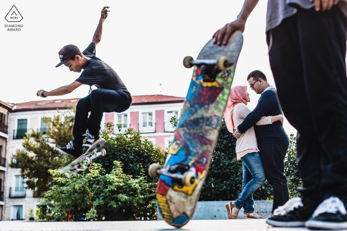 A Madrid couple during their pre-wedding portrait session with skateboarders | Spain street photographer