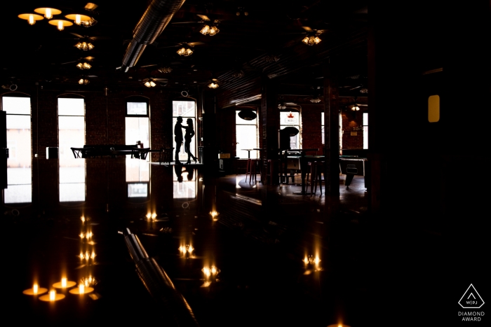 Portrait of engaged couple Silhouetted on Stage in MN.