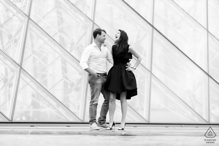 Photo by: <a href="https://www.wpja.com/photos/diamond-award-top-wedding-engagement-photographer/2348316">Simon Cassanas - Paris Île-de-France black and white engagement images of a couple laughing on the streets | Paris photographer pre-wedding session for portraits