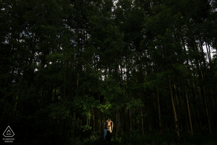 Casal do Colorado se beijando, seu amor iluminado pela luz do fotógrafo