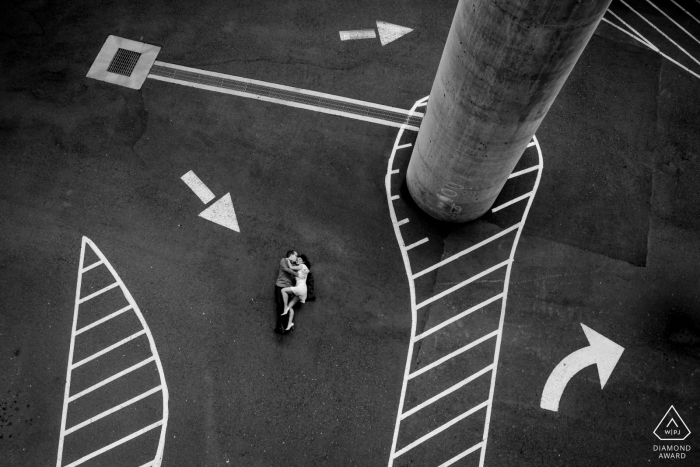 Urban South Carolina couple poses on concrete parking garage floor for a portrait