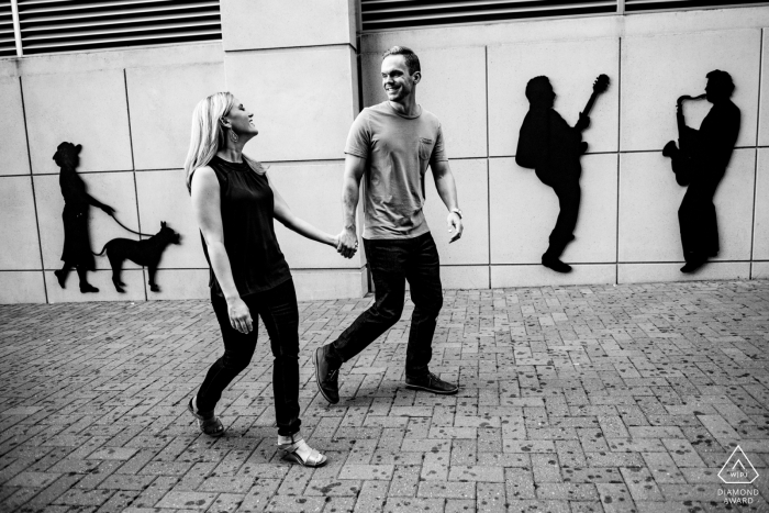 A North Carolina newly engaged couple walk down the brick sidewalk