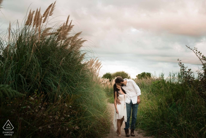 Biarritz couple in love strolls slowly down a romantic dirt path