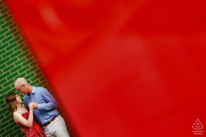 A Colorado couple framed by the contrasting colors of red and green