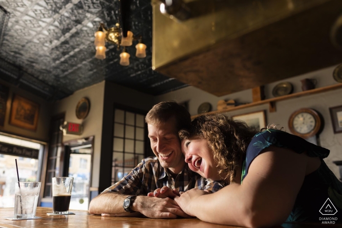 The Illinois couple sits close at a bar while laughing