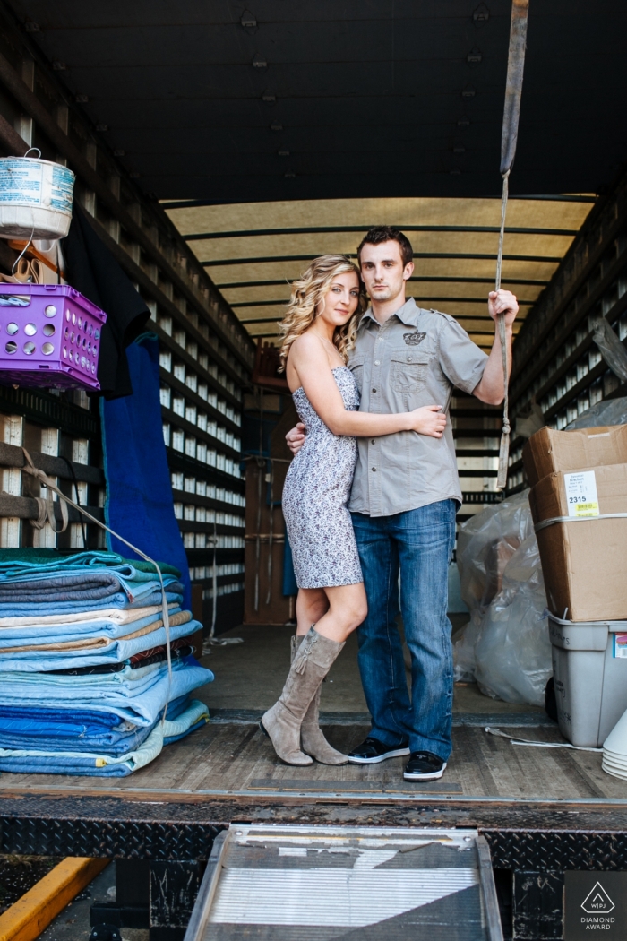 An urban Washington couple embraces in the back of a moving truck