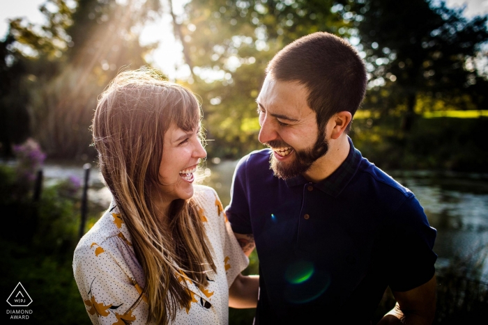 The Illinois engaged couple laughs with each other while drenched in sunlight