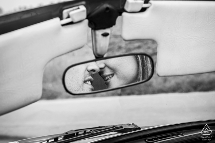 A Lille newly engaged couple is reflected in a vintage car mirror