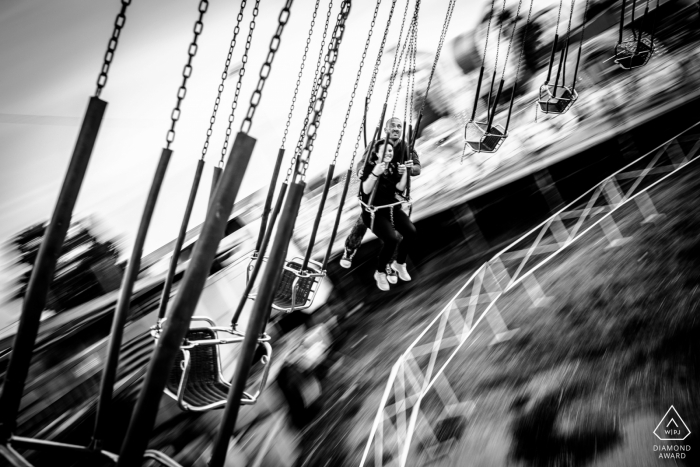 Siracusa couple enjoy a romantic portrait session as they swing around, their motion blurred by the fast-paced ride