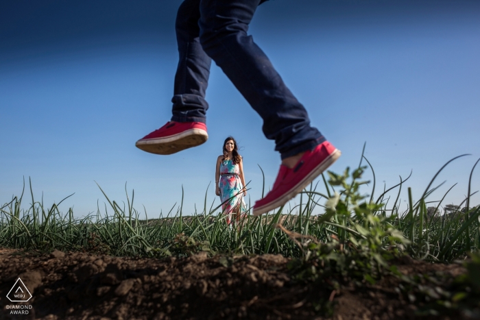 The playful Lima couple in an open field with sparse grass