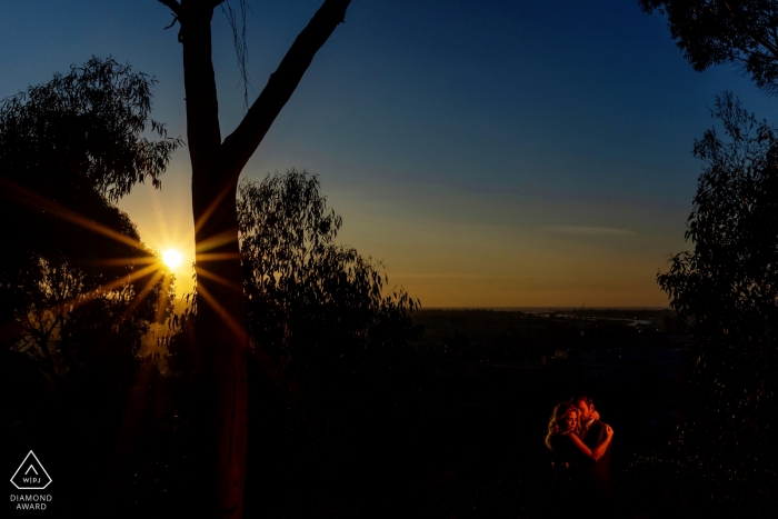 A sunset atmosphere for the embracing couple in California