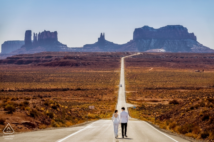 Desert loving engaged couple walked away hand in hand on the highway