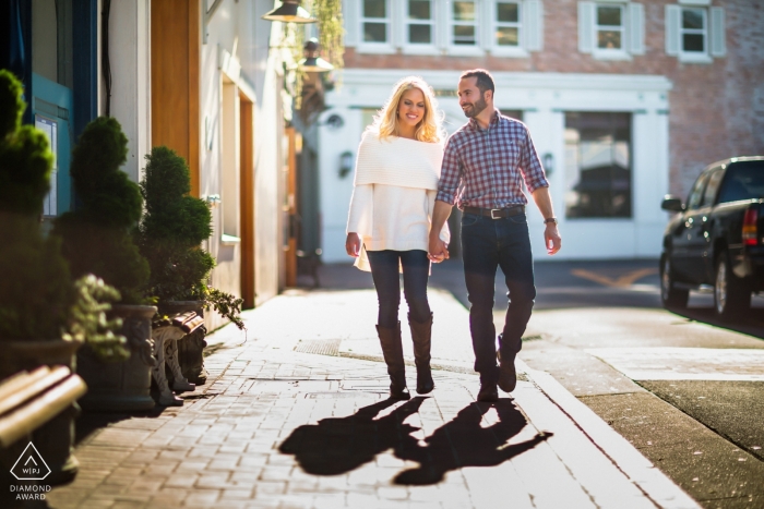 California couple walking cobblestone sidewalk in sunshine before their wedding