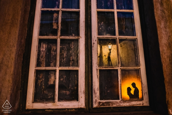 Minas Gerais Engagement Photograph of a couple lit and reflected in glass windows