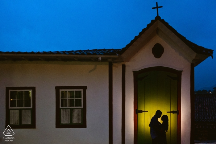 Ouro Preto lit portrait of engaged couple at a church