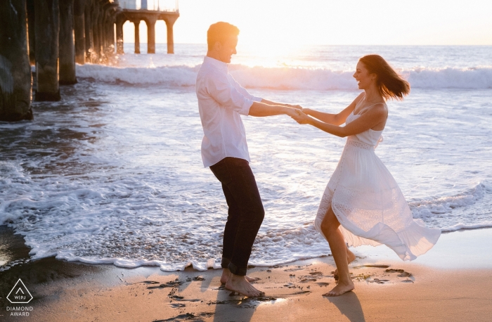 Photo by: <a href="https://www.wpja.com/photos/diamond-award-top-wedding-engagement-photographer/2418081">Jessica Weiser - Portland Maine Los Angeles, CA | West coast love at the beach with a pier at sunset | Engagement Photographer
