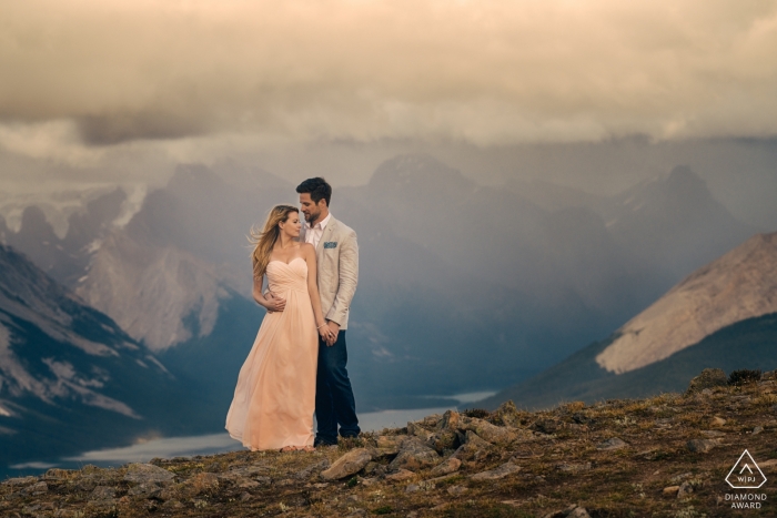 Photo by: <a href="https://www.wpja.com/photos/diamond-award-top-wedding-engagement-photographer/2418716">Dorota Karpowicz - Edmonton Alberta Jasper National Park, AB, Canada Mountains behind formal couple during portraits