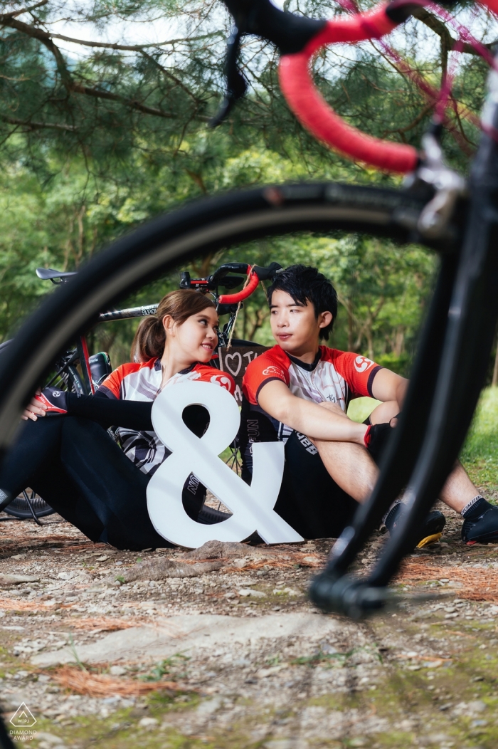 Photo by: <a href="https://www.wpja.com/photos/diamond-award-top-wedding-engagement-photographer/2427531">Tao-Hsuan Tzu - Ji’an Township, Hualien County Taiwan Hualien Bicycle lovers - portrait of a young athletic couple through the spokes of a bike