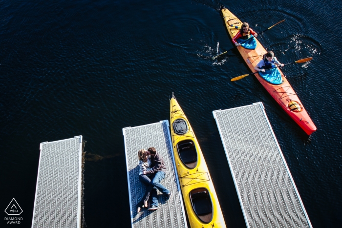 Photo by: <a href="https://www.wpja.com/photos/diamond-award-top-wedding-engagement-photographer/2427001">Ron Storer - Auburn Washington Engagement Session Puget Sound - Couple laying down kissing on dock in marina