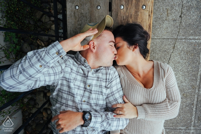 Creative Engagement Session Western Washington - Couple kissing on bench 