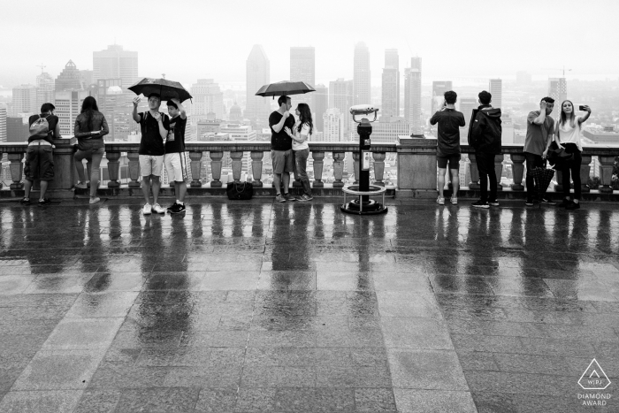 Photo de fiançailles en noir et blanc sous la pluie au belvédère du mont Royal