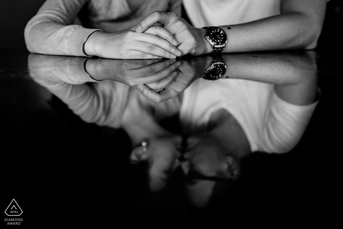 apartment engagement portraits - couple caught in a reflection on kitchen table top 