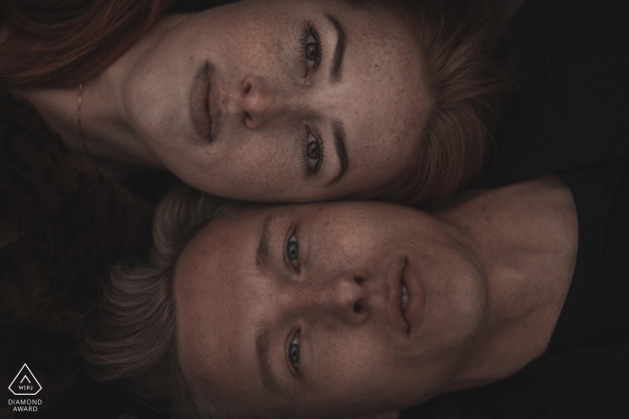 Photo by: <a href="https://www.wpja.com/photos/diamond-award-top-wedding-engagement-photographer/2451666">Roy van der Wens - Tilburg Noord Brabant Dinand engagement photo shoot | Special portrait of couple laying next to each other.