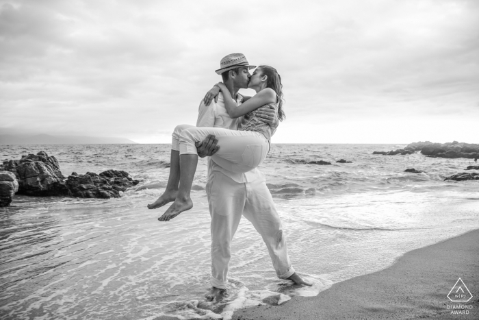 Photo by: <a href="https://www.wpja.com/photos/diamond-award-top-wedding-engagement-photographer/2445711">Juan Carlos Calderon - Puerto Vallarta Jalisco Puerto Vallarta, Mexico engagement portrait on the beach - she said yes and he carries her in the rising tide