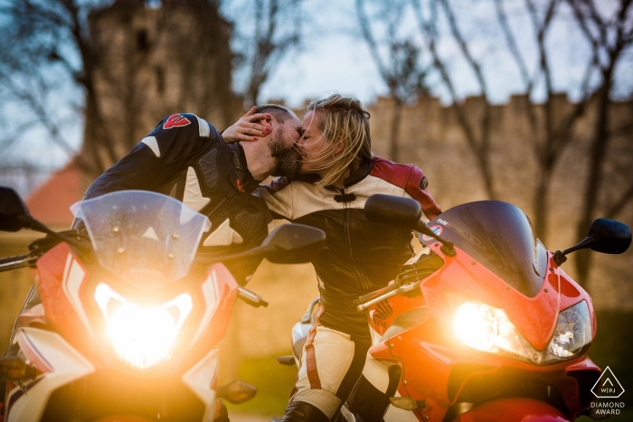 República Checa Moto Compromiso sesión fotográfica | Pareja besándose con sus faros de motocicleta encendidos.