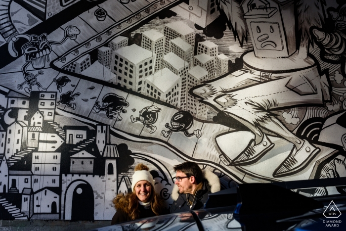 Photo by: <a href="https://www.wpja.com/photos/diamond-award-top-wedding-engagement-photographer/2449021">Esther Gibbons - Montreal Quebec Montreal, Quebec pre-wedding portrait shoot on Saint-Laurent street | Couple in the sun near a graffiti mural