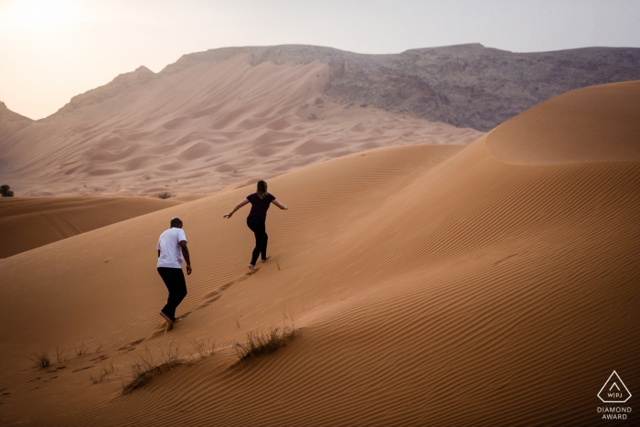 Photo by: <a href="https://www.wpja.com/photos/diamond-award-top-wedding-engagement-photographer/2450651">Bindi Richardson - Dubai Maleiha Desert, Dubai Photo Shoot with Engaged Couple | Exploring the desert sand