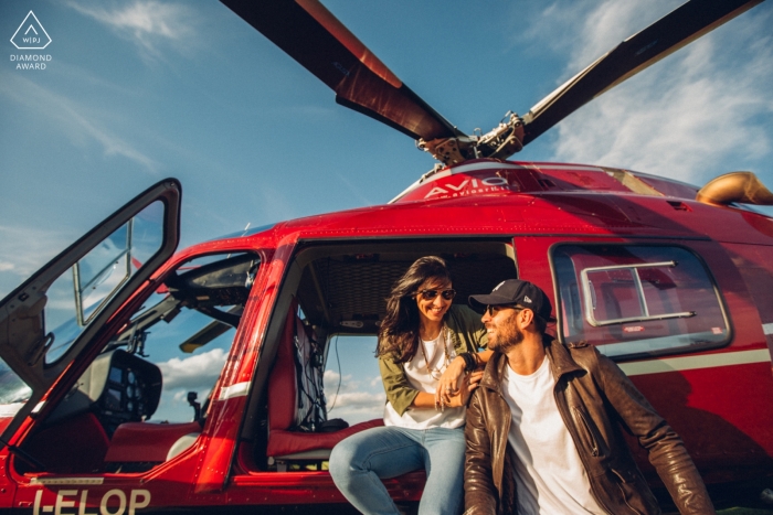 Vicenza pre-wedding portraits of a Couple sitting on red helicopter 