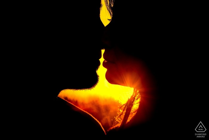 Photo by: <a href="https://www.wpja.com/photos/diamond-award-top-wedding-engagement-photographer/2429796">Simona Cancelli - Siracusa Siracusa Siracusa couple Photos in sicily | Burning love and a burning sun | tightly cropped silhouette profiles