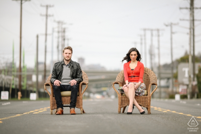 Photo by: <a href="https://www.wpja.com/photos/diamond-award-top-wedding-engagement-photographer/2445921">Ron Storer - Auburn Washington Downtown Seattle engagement photos | Couple sitting on chairs in the middle of Seattle street