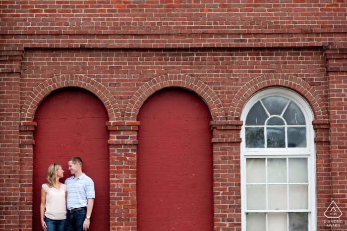 Photo by: <a href="https://www.wpja.com/photos/diamond-award-top-wedding-engagement-photographer/2452201">Kevin Trimmer - Providence Rhode Island Boston, MA engagement portraits - Couple in blanked out red window frame