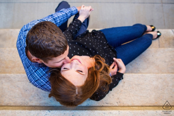 Couple sits on steps together for Manhattan New York Engagement Session Couple sits on steps together for Manhattan New York Engagement Session